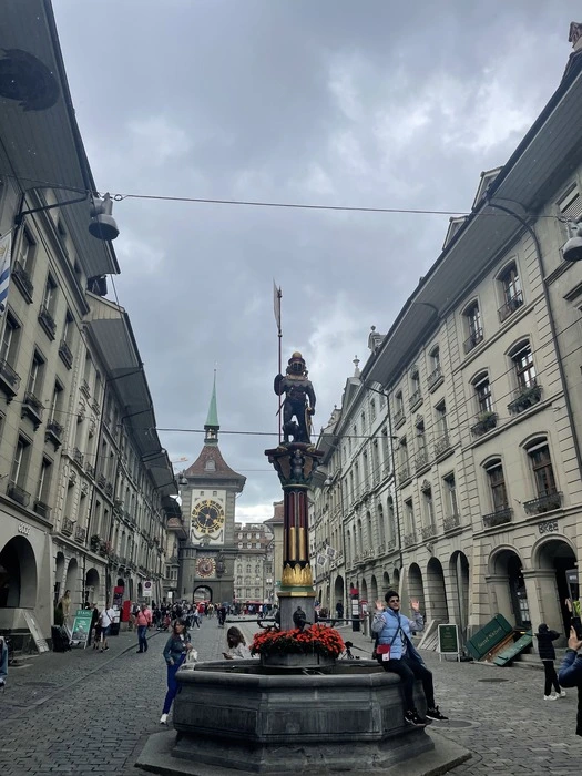 A statue in the old town in Bern with a water fountain