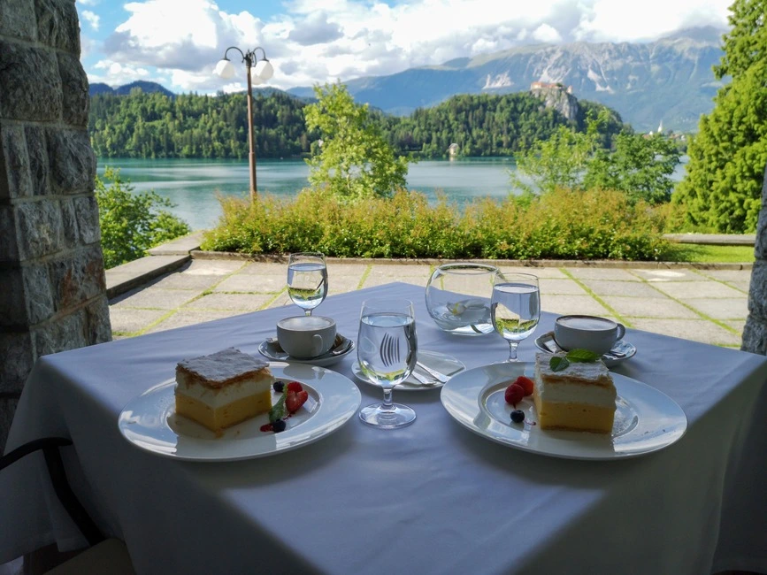 Having a bled cake next to a beautiful view of Lake Bled