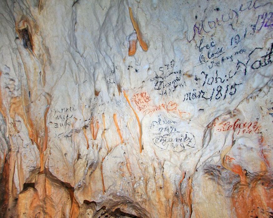 signatures on the cave walls in Postojna Cave