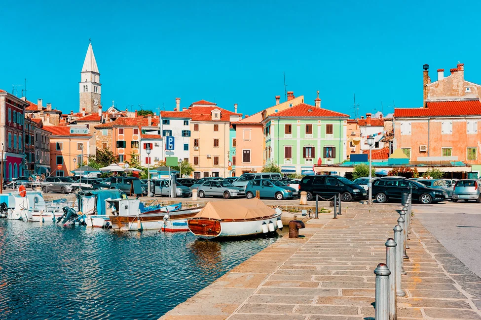 Walking along the Izola Promenade located in Slovenia viewing all its pastel coloured homes