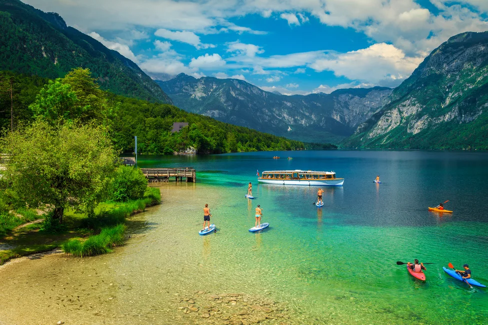 People doing water activities on Lake Bohinj in Slovenia