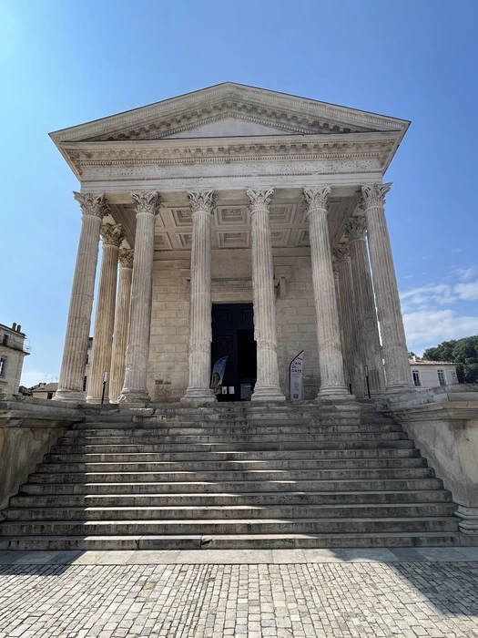 Outside the Maison carrée in Nîmes on a day trip from Avignon