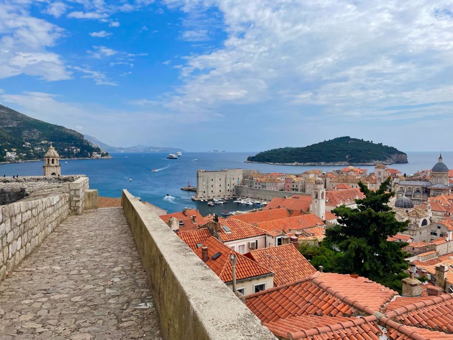 View of Dubrovnik's Old Town from the City Walls, showcasing Dubrovnik's terracotta rooftops and the Adriatic Sea in the background.
